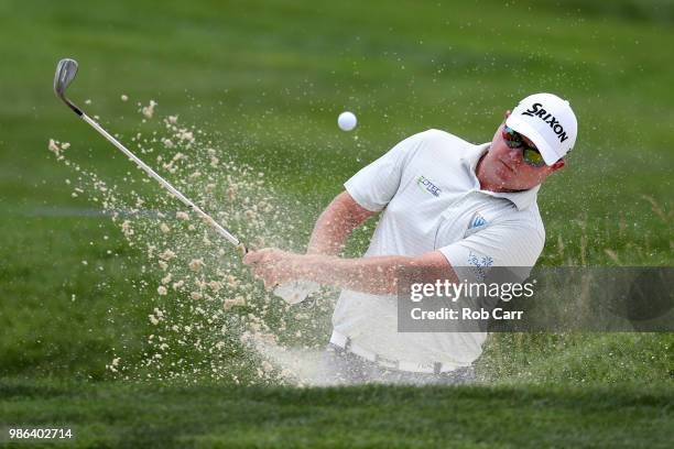 Ted Potter Jr. Hits out of a bunker on the first hole during the first round of the Quicken Loans National at TPC Potomac on June 28, 2018 in...