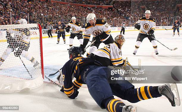 Tim Connolly of the Buffalo Sabres dives for a loose puck in front of Tuukka Rask and Johnny Boychuk of the Boston Bruins in Game Five of the Eastern...