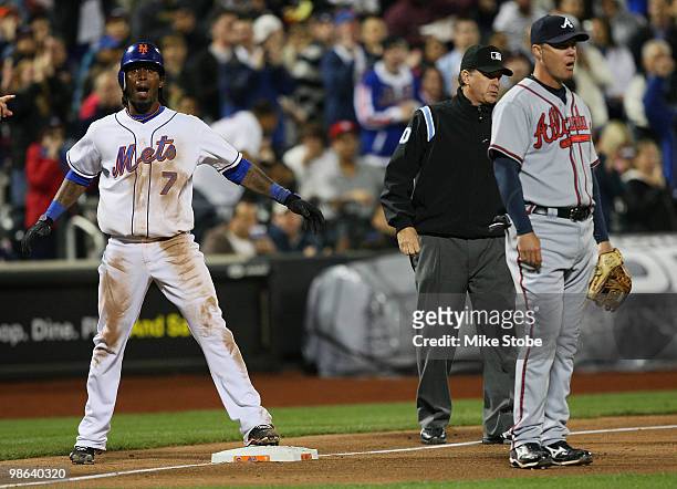 Jose Reyes of the New York Mets celebrates after hitting a sixth inning triple as Chipper Jones of the Atlanta Braves looks on during their game on...
