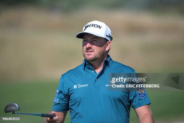 Northern Ireland golfer Graeme McDowell reacts with his putter as he competes in the HNA Open de France, as part of the European Tour 2018, at the...