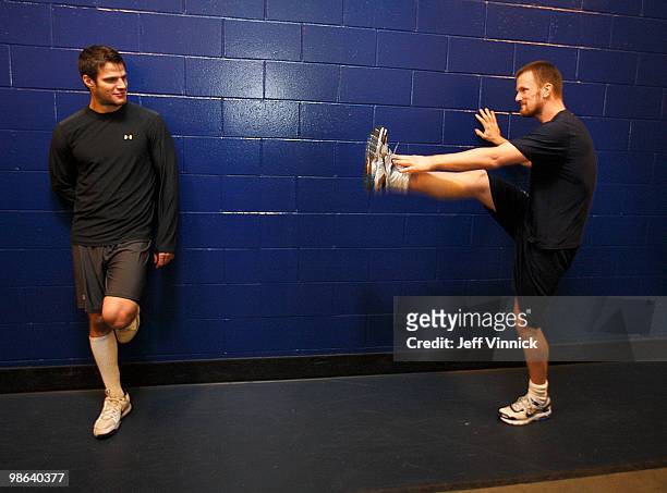 Kevin Bieksa of the Vancouver Canucks looks on as teammate Daniel Sedin stretches before Game Five of the Western Conference Quarterfinals against...