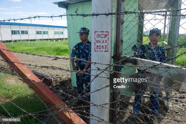 Armed Myanmar border guard police are posted at the gate of Nga Khu Ya camp in Maungdaw, Rakhine state, a facility to process Rohingya refugees...