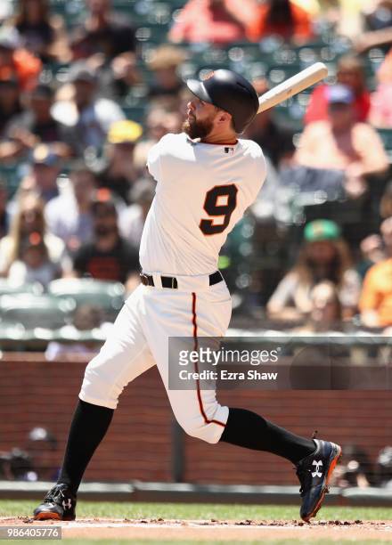 Brandon Belt of the San Francisco Giants hits a two-run home run against the Colorado Rockies in the first inning at AT&T Park on June 28, 2018 in...