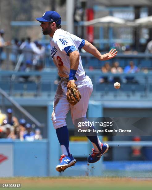 Chris Taylor of the Los Angeles Dodgers bobbles the ball as he is charged with an error off a ball hit by David Bote of the Chicago Cubs in the...