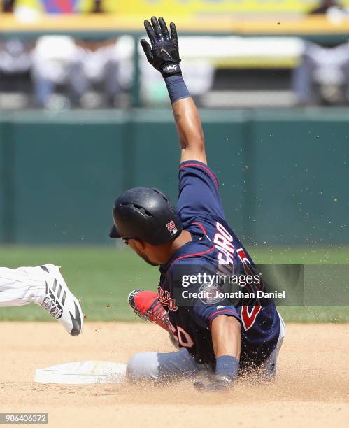 The relay throw hits Eddie Rosario of the Minnesota Twins in the arm as he slides into second base with a double in the 6th inning against the...