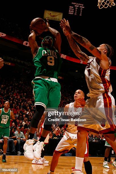 Rajon Rondo of the Boston Celtics shoots against Michael Beasley of the Miami Heat in Game Three of the Eastern Conference Quarterfinals during the...