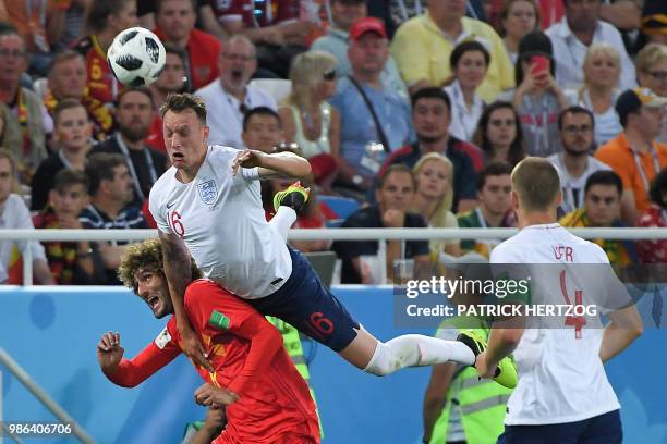 England's defender Phil Jones jumps on Belgium's midfielder Marouane Fellaini during the Russia 2018 World Cup Group G football match between England...