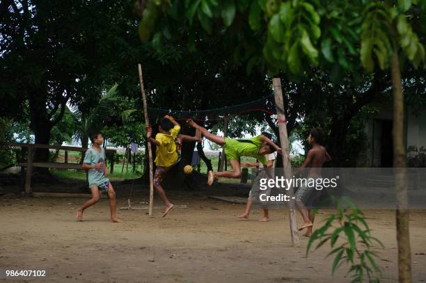Ethnic Rakhine children play chinlone inside monastery at Inn Din village, Rakhine state on 28 June 2018. - More than 700,000 Rohingya Muslims were...