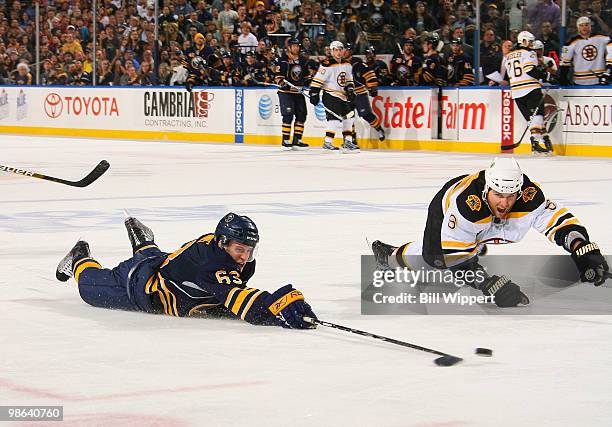 Tyler Ennis of the Buffalo Sabres dives to score a third period empty net goal past Dennis Wideman of the Boston Bruins in Game Five of the Eastern...