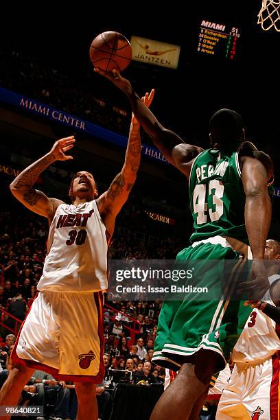 Kendrick Perkins of the Boston Celtics battles for a rebound against Michael Beasley of the Miami Heat in Game Three of the Eastern Conference...