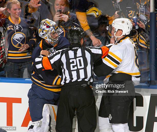 Referee Tim Peel separates Ryan Miller of the Buffalo Sabres and Miroslav Satan of the Boston Bruins during an altercation with .02 seconds left in...