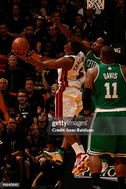 Mario Chalmers of the Miami Heat shoots against Tony Allen of the Boston Celtics in Game Three of the Eastern Conference Quarterfinals during the...