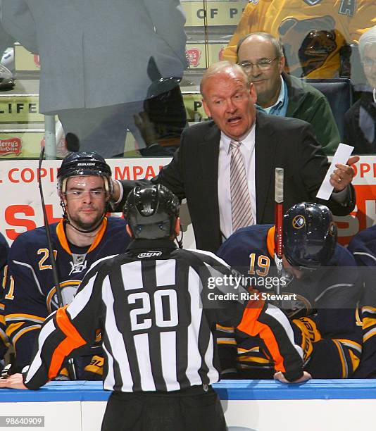 Lindy Ruff , head coach of the Buffalo Sabres talks to referee Tim Peel during a tim out against the Boston Bruins in Game Five of the Eastern...