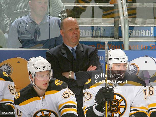 Claude Julien, head coach of the Boston Bruins stands on the bench during pay against the Buffalo Sabres in Game Five of the Eastern Conference...
