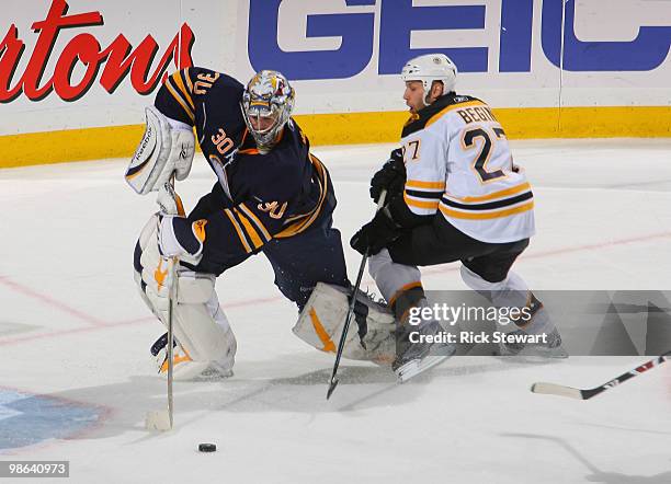 Ryan Miller of the Buffalo Sabres controls the puck around Steve Begin of the Boston Bruins in Game Five of the Eastern Conference Quarterfinals...