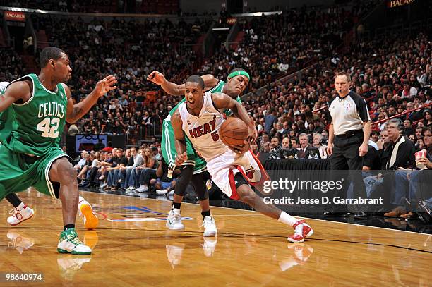 Mario Chalmers of the Miami Heat drives against Rajon Rondo of the Boston Celtics in Game Three of the Eastern Conference Quarterfinals during the...