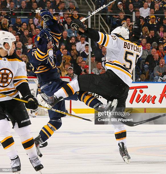 Tyler Ennis of the Buffalo Sabres stays on his feet in a mid ice collison with Johnny Boychuk of the Boston Bruins in Game Five of the Eastern...