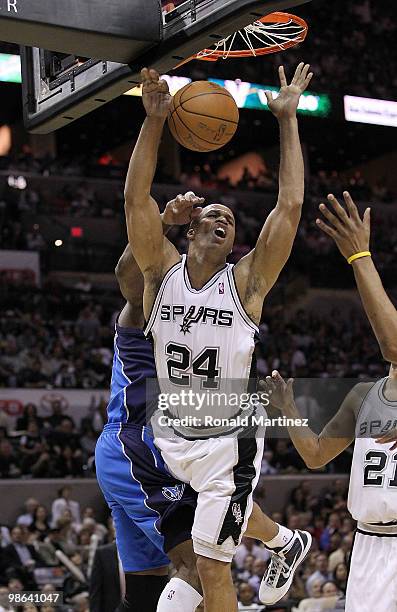 Forward Richard Jefferson of the San Antonio Spurs is fouled by Erick Dampier of the Dallas Mavericks in Game Three of the Western Conference...