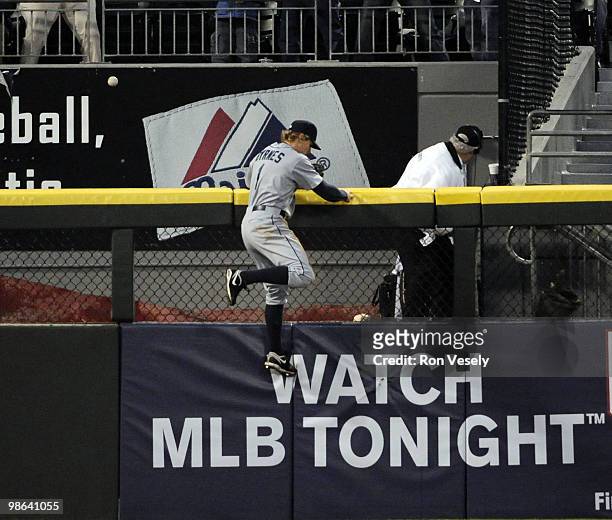 Eric Byrnes of the Seattle Mariners cannot catch the home run hit by Carlos Quentin of the Chicago White Sox in the second inning against the Seattle...