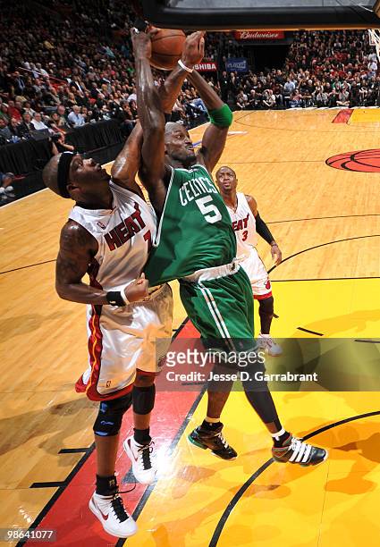Kevin Garnett of the Boston Celtics rebounds against Jermaine O'Neal of the Miami Heat in Game Three of the Eastern Conference Quarterfinals during...