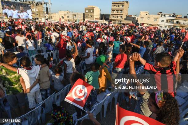 Tunisian football fans sing their national anthem as they watch the Russia 2018 World Cup Group G match between Tunisia and Panama in the...