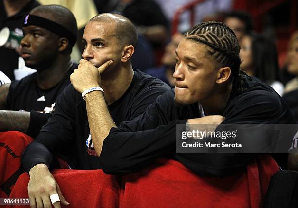 Jermaine O'Neal, Carlos Arroyo and Miachael Beasley of the Miami Heat sit on the bench during a 100-98 loss to the Boston Celtics in Game Three of...