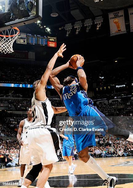Erick Dampier of the Dallas Mavericks shoots against and is blocked by Tim Duncan of the San Antonio Spurs in Game Three of the Western Conference...
