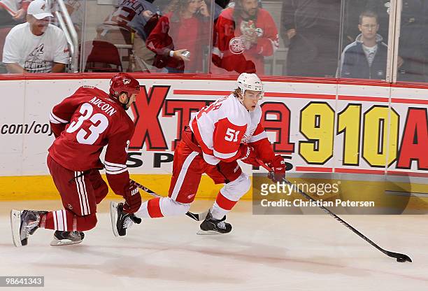 Valtteri Filppula of the Detroit Red Wings skates with the puck past Adrian Aucoin of the Phoenix Coyotes in the first period of Game Five of the...
