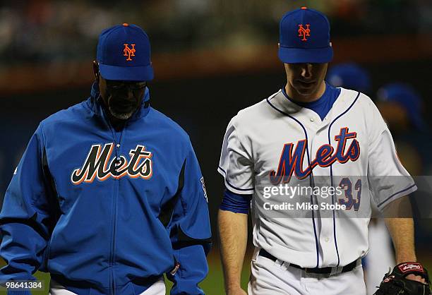 Manager Jerry Manuel of the New York Mets walks John Maine off the field after suffering an injury in the forth inning against the Atlanta Braves on...
