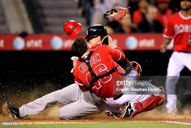 Mark Teixeira of the New York Yankees collides with catcher Bobby Wilson of the Los Angeles Angels of Anaheim as he scores in the third inning on...