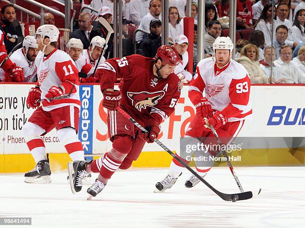 Ed Jovanovski of the Phoenix Coyotes skates the puck into the offensive zone against Johan Franzen of the Detroit Red Wings in Game Five of the...