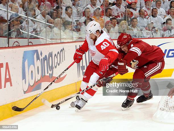 Zbynek Michaelk of the Phoenix Coyotes takes the puck away from Henrik Zetterberg of the Detroit Red Wings in Game Five of the Western Conference...