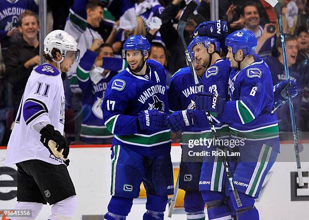 Ryan Kesler, Michael Grabner, Sami Salo of the Vancouver Canucks celebrate teammate Alexander Edler's goal while Anze Kopitar of the Los Angeles...