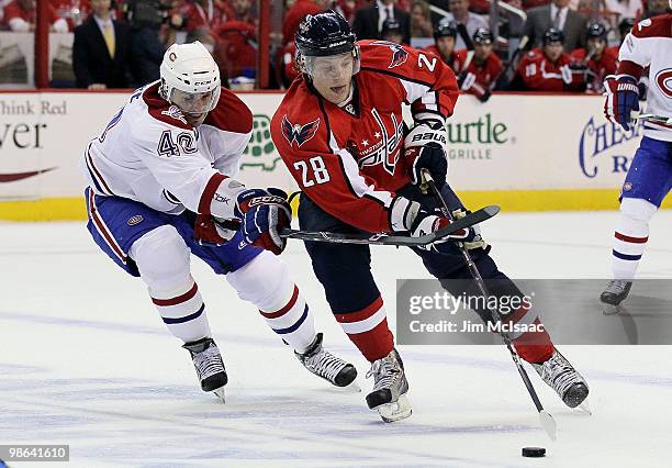 Alexander Semin of the Washington Capitals skates against Dominic Moore of the Montreal Canadiens in Game Five of the Eastern Conference...