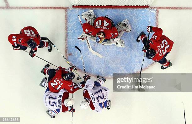 Semyon Varlamov, Brooks Laich, Tyler Sloan, and Jeff Shultz of the Washington Capitals defend against Glen Metropolit and Brian Gionta of the...