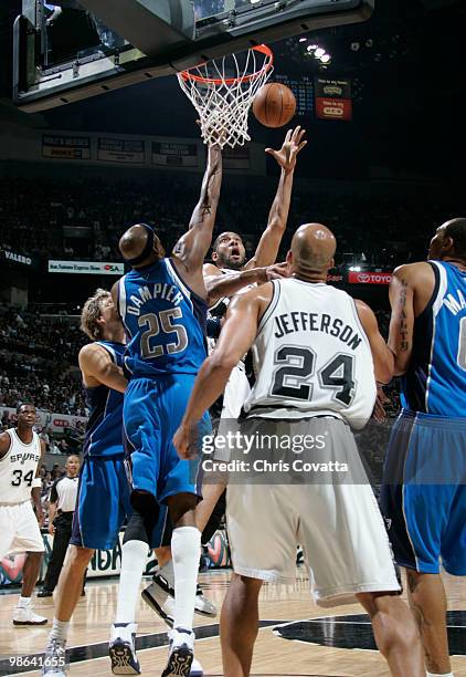 Tim Duncan of the San Antonio Spurs shoots against Erick Dampier of the Dallas Mavericks in Game Three of the Western Conference Quarterfinals during...