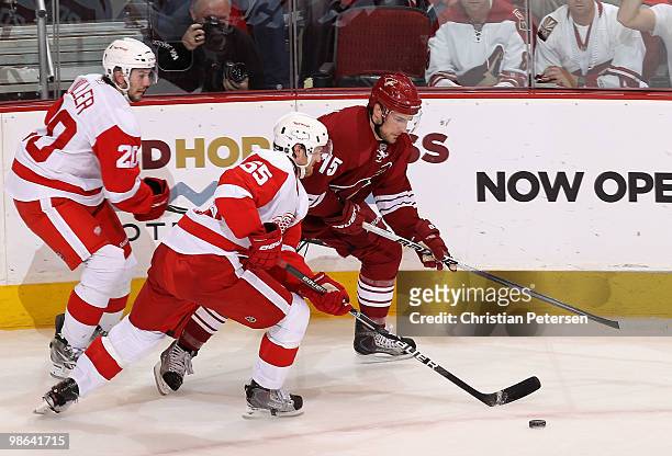Niklas Kronwall of the Detroit Red Wings skates with the puck under pressure from Matthew Lombardi of the Phoenix Coyotes in the second period of...