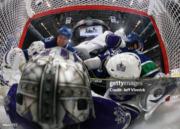 Kyle Wellwood of the Vancouver Canucks falls on top of Los Angeles goaltender Jonathan Quick in first period action in Game Five of the Western...