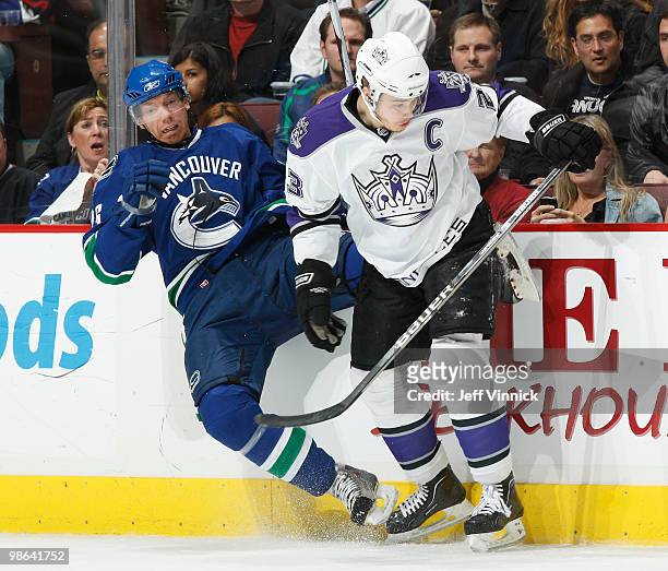 Dustin Brown of the Los Angeles Kings checks Mikael Samuelsson of the Vancouver Canucks in Game Five of the Western Conference Quarterfinals during...