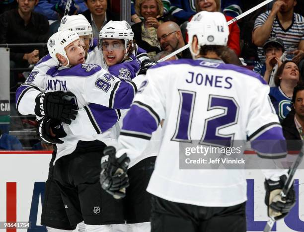 Michal Handzus of the Los Angeles Kings is congratulated on his goal by team mates Randy Jones, Ryan Smyth and Anze Kopitar in Game Five of the...