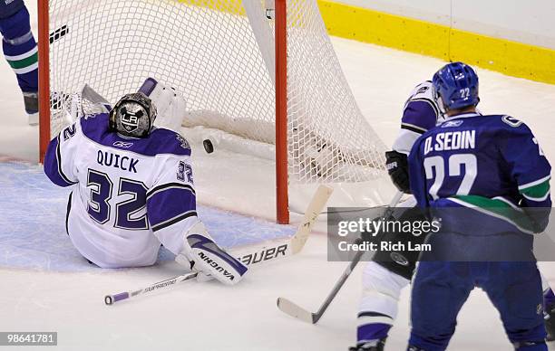 Daniel Sedin of the Vancouver Canucks watches the puck hit the ice after firing a shot past goalie Jonathan Quick of the Los Angeles Kings during the...