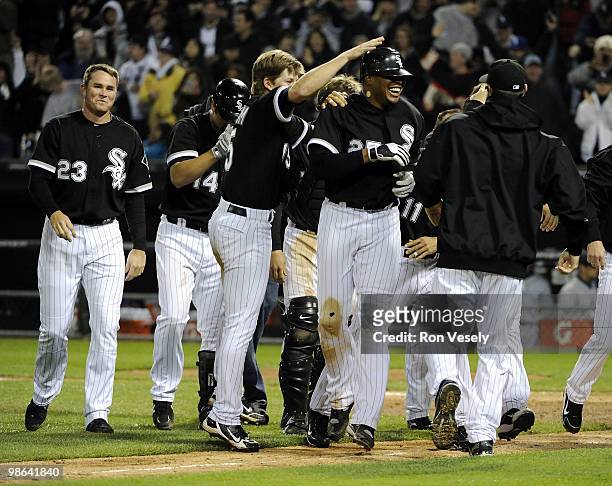 Teammates celebrate with Andruw Jones of the Chicago White Sox after Jones hit a walk-off home run off against the Seattle Mariners on April 23, 2010...