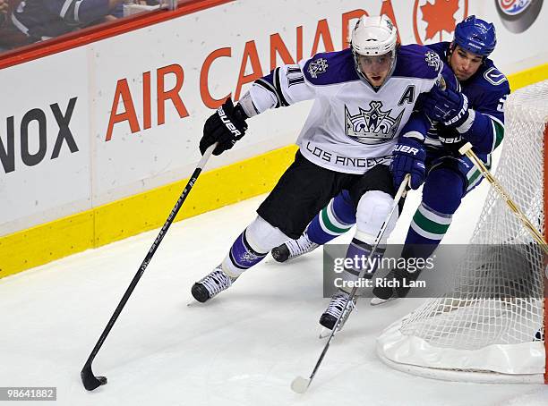 Anze Kopitar of the Los Angeles Kings tries for a wrap-around while being checked by Shane O'Brien of the Vancouver Canucks during the second period...