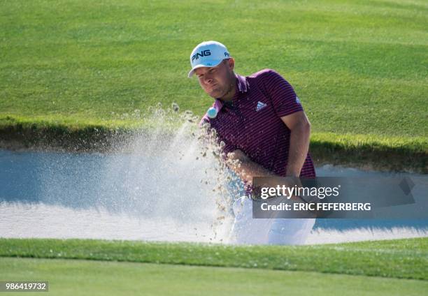 England's golfer Tyrrell Hatton plays from a bunker as he competes in the HNA Open de France, as part of the European Tour 2018, at the...