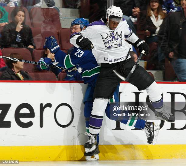 Wayne Simmonds of the Los Angeles Kings checks Alexander Edler during second period action in Game Five of the Western Conference Quarterfinals...