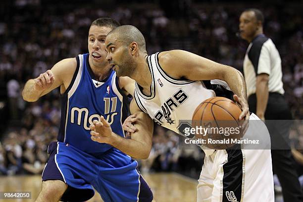 Guard Tony Parker of the San Antonio Spurs dribbles the ball past Jose Juan Barea of the Dallas Mavericks in Game Three of the Western Conference...