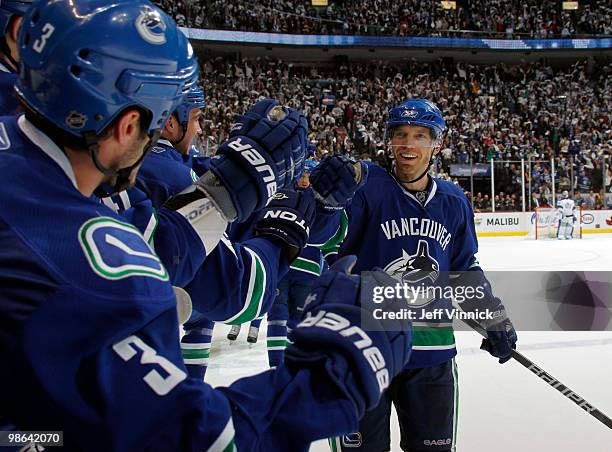 Mikael Samuelsson is congratulated by his Vancouver Canucks team mates after scoring in the second period in Game Five of the Western Conference...