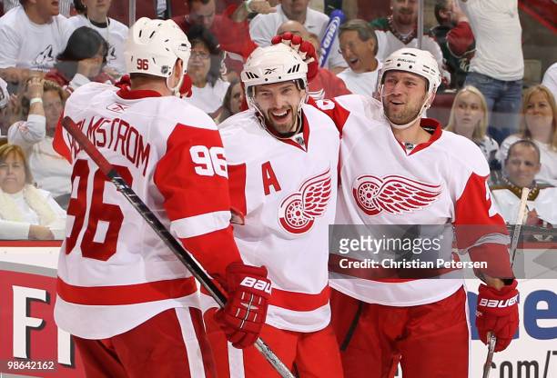 Pavel Datsyuk of the Detroit Red Wings is congratulated by teammates Tomas Holmstrom and Brian Rafalski after Datsyuk scored a third period goal...