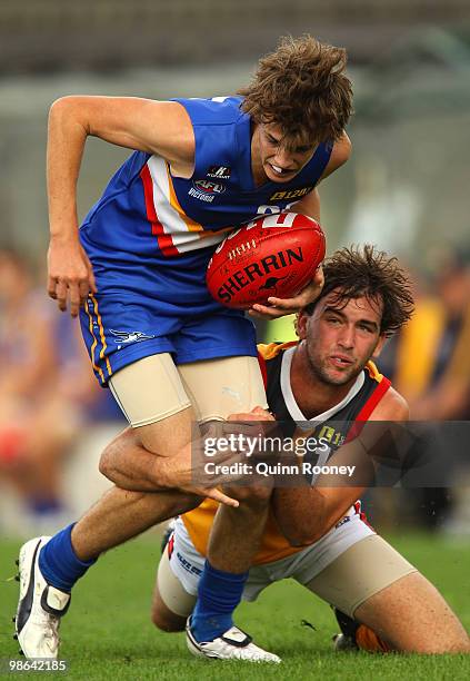 Scott Carroll of the Ranges is tackled by Jarryd Amalfi of the Stingrays during the round four TAC Cup match between the Eastern Ranges and Dandenong...