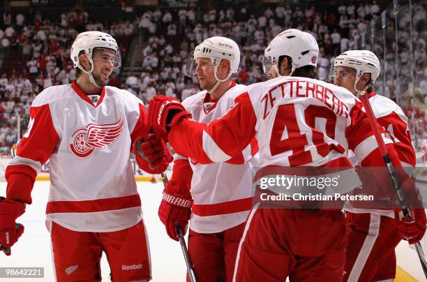 Henrik Zetterberg of the Detroit Red Wings is congratulated by teammates Drew Miller, Nicklas Lidstrom and Valtteri Filppula after Zetterberg scored...